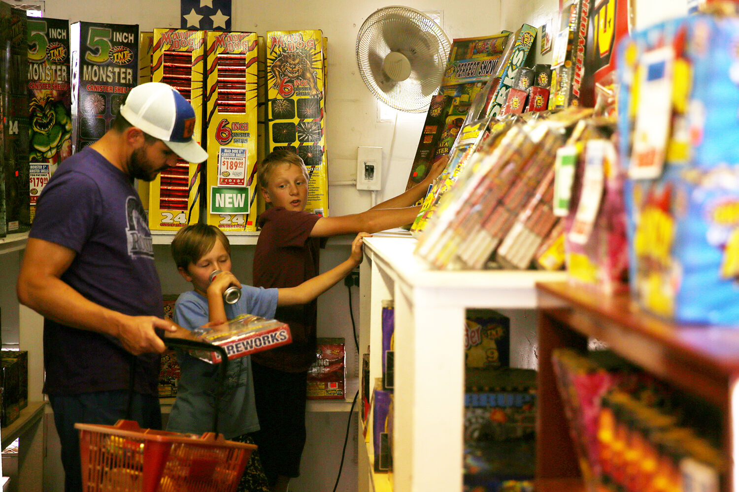 Abel Teten, 13, helps pick out fireworks with James Cummings